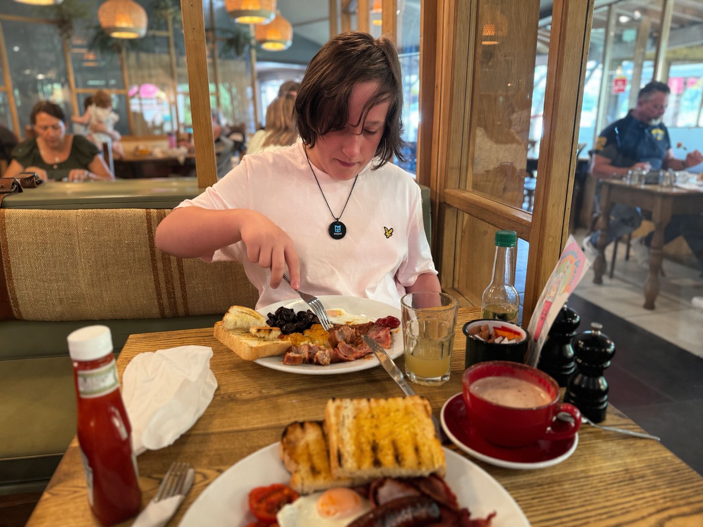 Xavier wearing HelpBadge in a restaurant