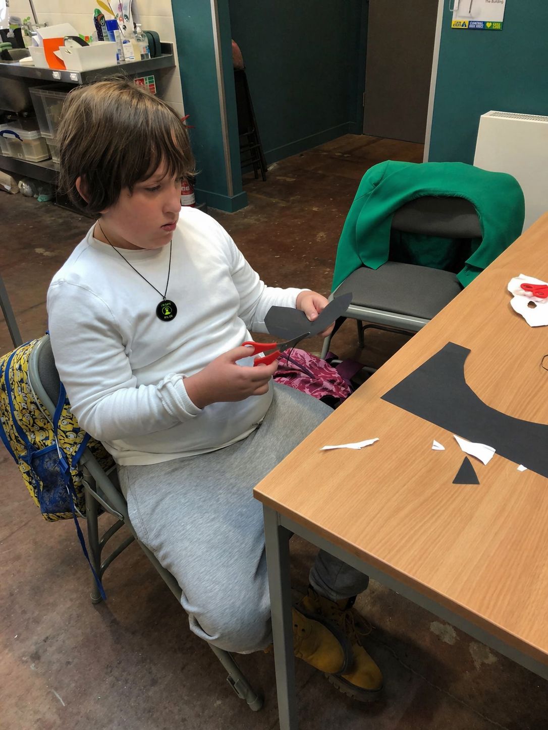 Xavier wearing HelpBadge during an activity